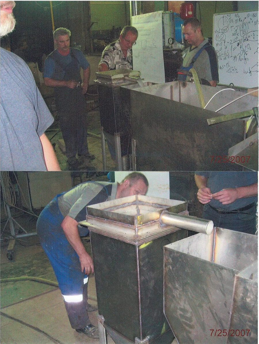 Team members working on an early mining prototype in a workshop